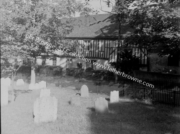 GRAVEYARD WITH OLD TIMNERED HOUSE